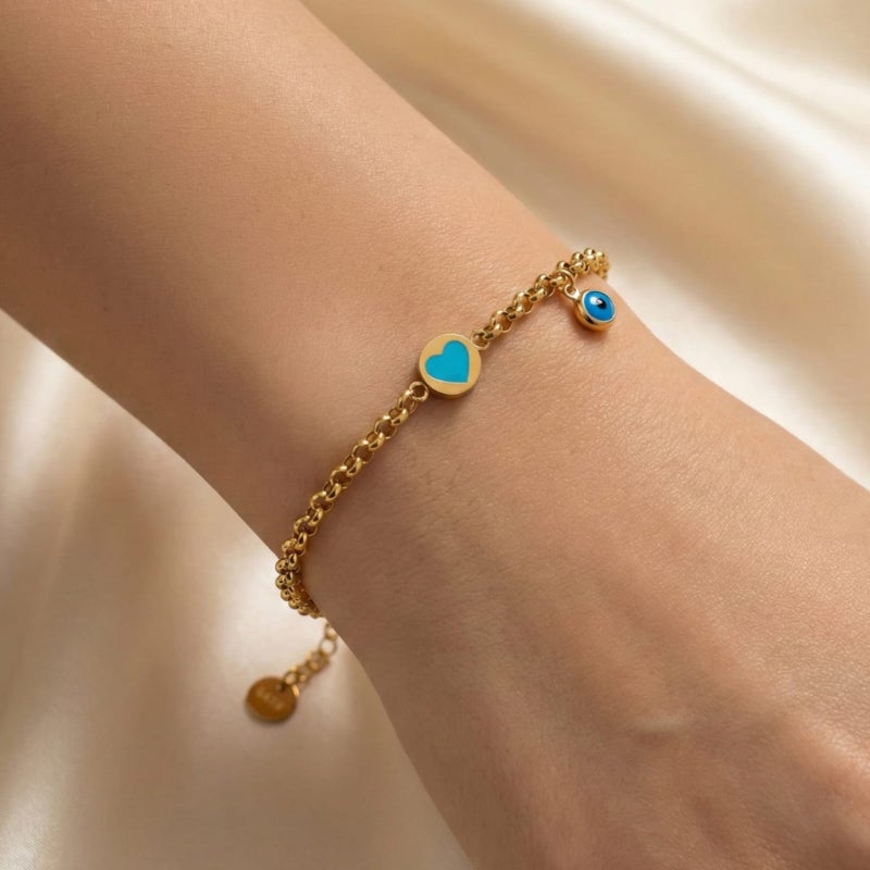 A gold-tone bracelet crafted from rust-resistant stainless steel, featuring a delicate turquoise heart design and a blue "eye" charm. Its modern design complements any look, and it has an adjustable clasp for a perfect fit. - Image 3